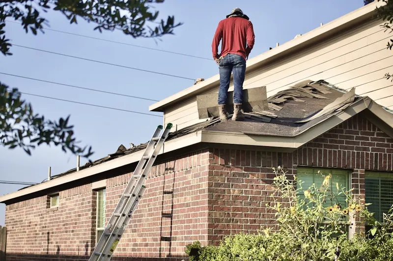 Professional roofer working on a residential roof in Pines Lake